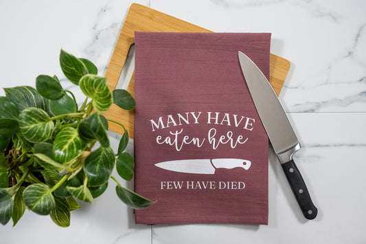 Many Have Eaten Here, Few Have Died Wine Tea Towel with White Ink