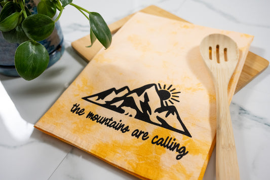 The Mountains Are Calling Orange Tie-Dye Tea Towel with Black Ink