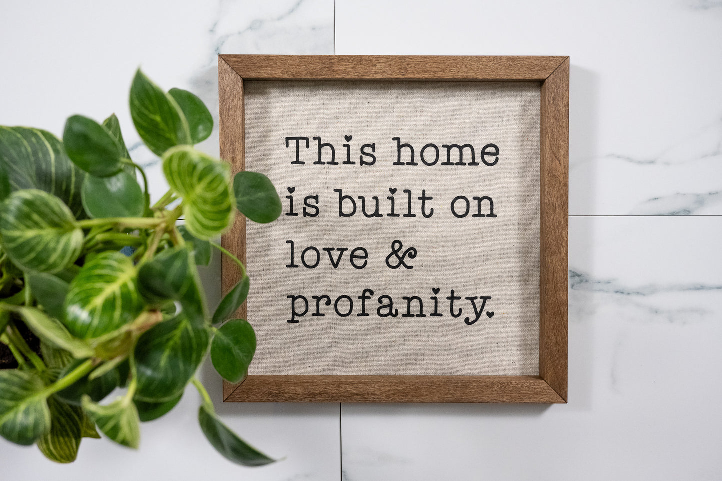 This Home is Build on Love & Profanity Sign with Walnut Frame and Black Ink