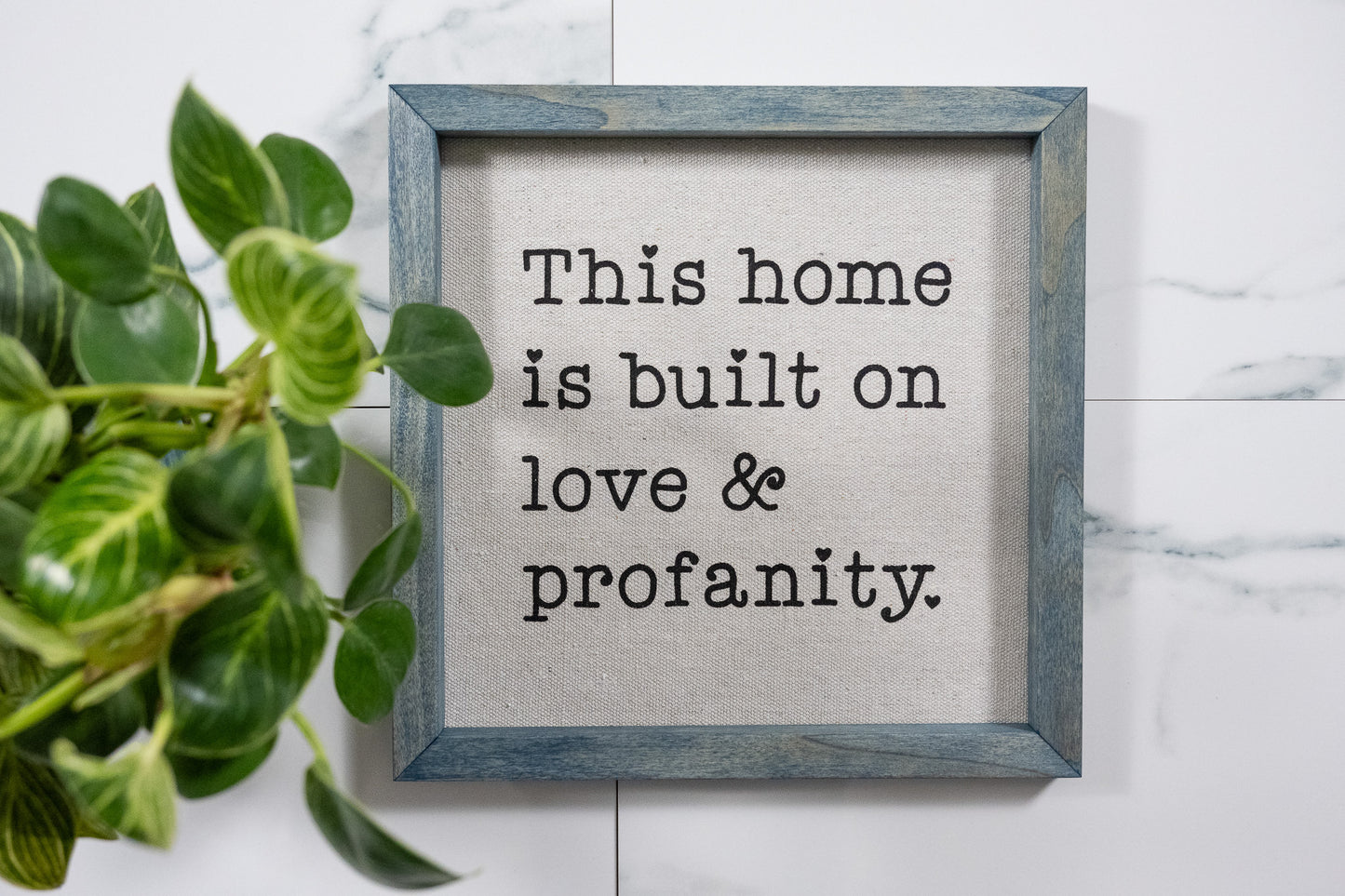 This Home is Build on Love & Profanity Sign with Worn Navy Frame and Black Ink